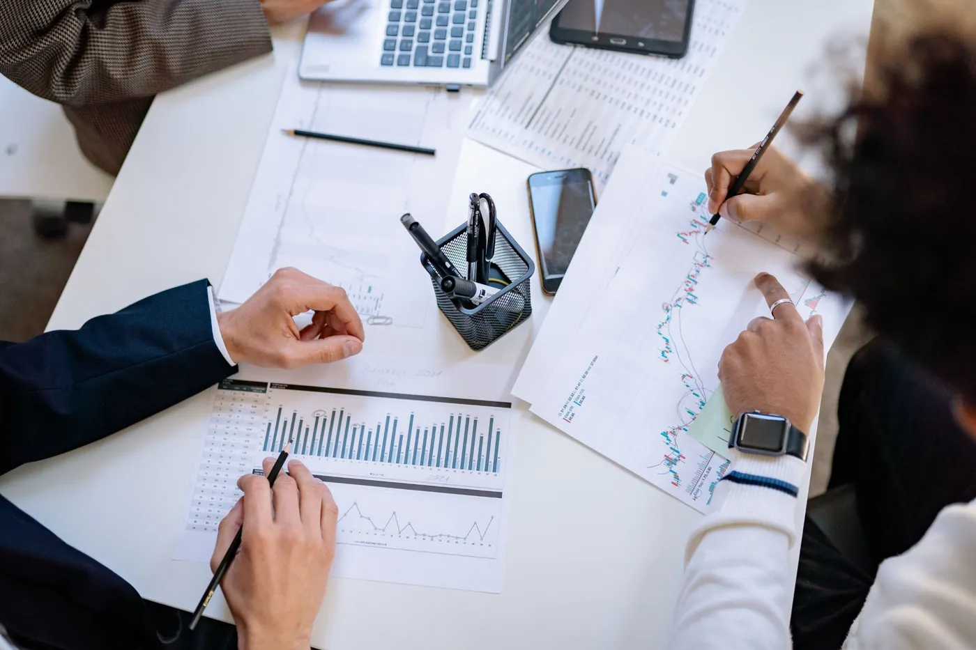 Analysts reviewing market and consumption data